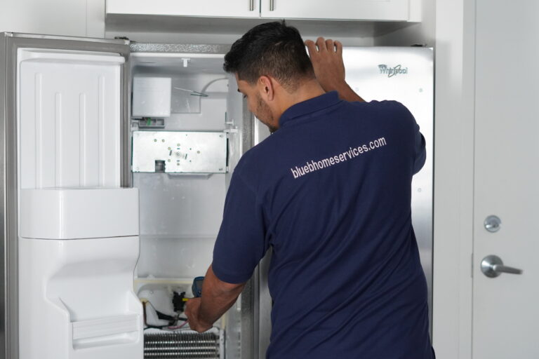 Tech cleaning dusty refrigerator condenser coils in Dania Beach. Refrigerator Not Cooling