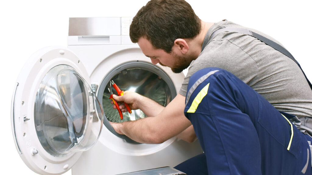 Certified technician inspecting an electric dryer heating element in a Broward County home.