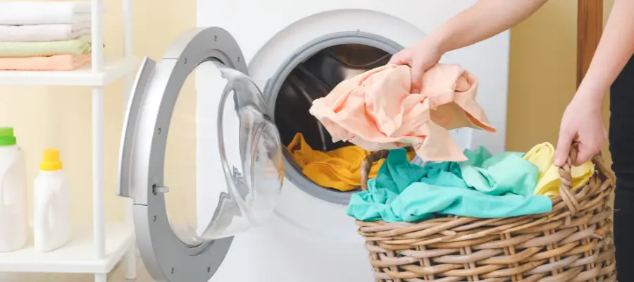 Technician checking the drum of a Whirlpool washer with a spin-cycle problem.