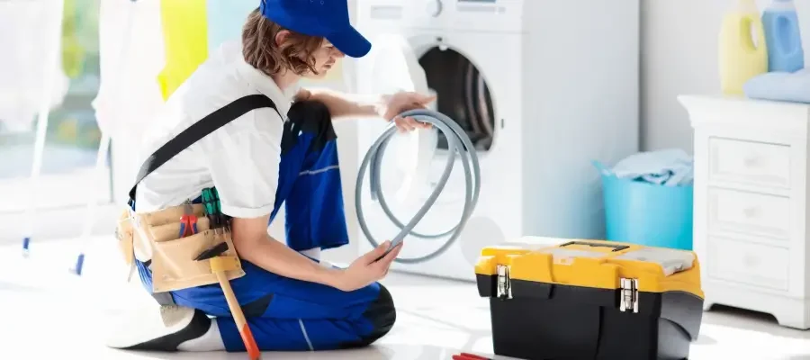 Drainage system being checked in a Whirlpool washer that is not spinning properly