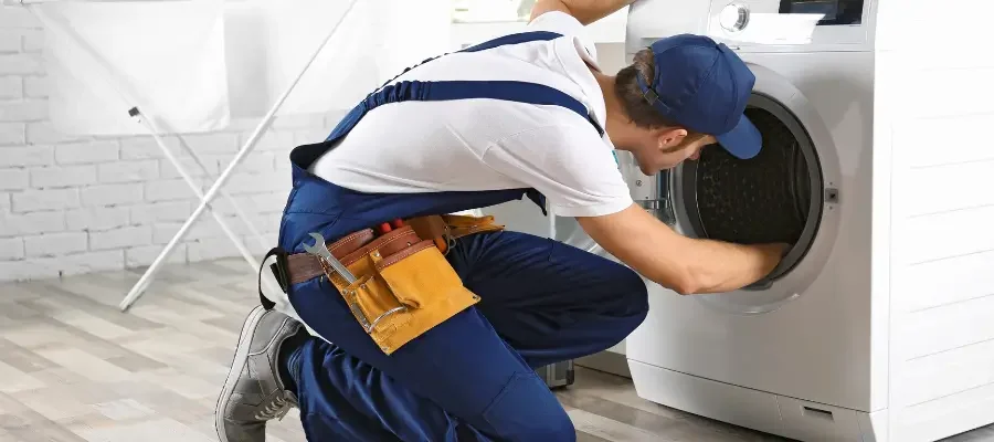 Whirlpool washer being inspected after it stopped spinning